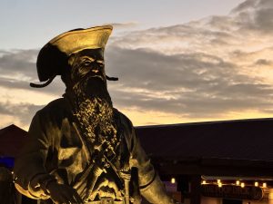 Blackbeard statue at sunset beside the pirate bar at Jolly Roger's Restaurant, St. Thomas