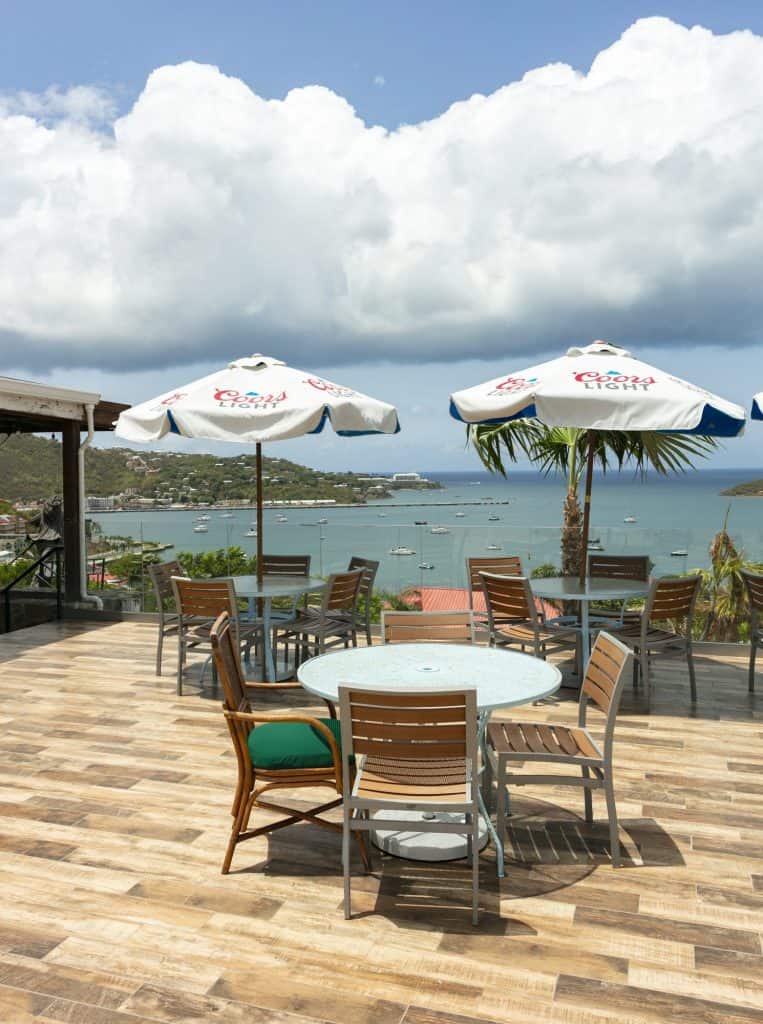 Dining table with umbrellas overlooking Charlotte Amalie harbor at Jolly Roger's