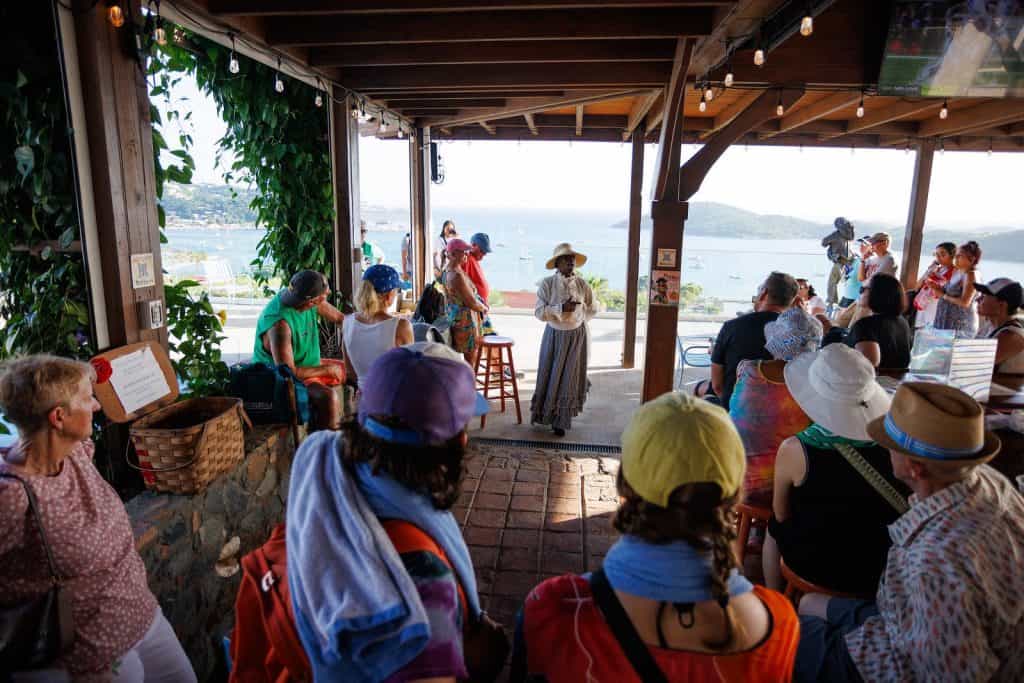 Guests enjoying the open-air pool bar at Jolly Roger's overlooking Charlotte Amalie harbor