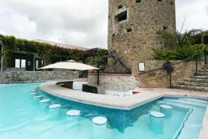 The pool and swim-up bar below the historic 1679 Skytsborg tower at Jolly Roger's, Blackbeard's Castle