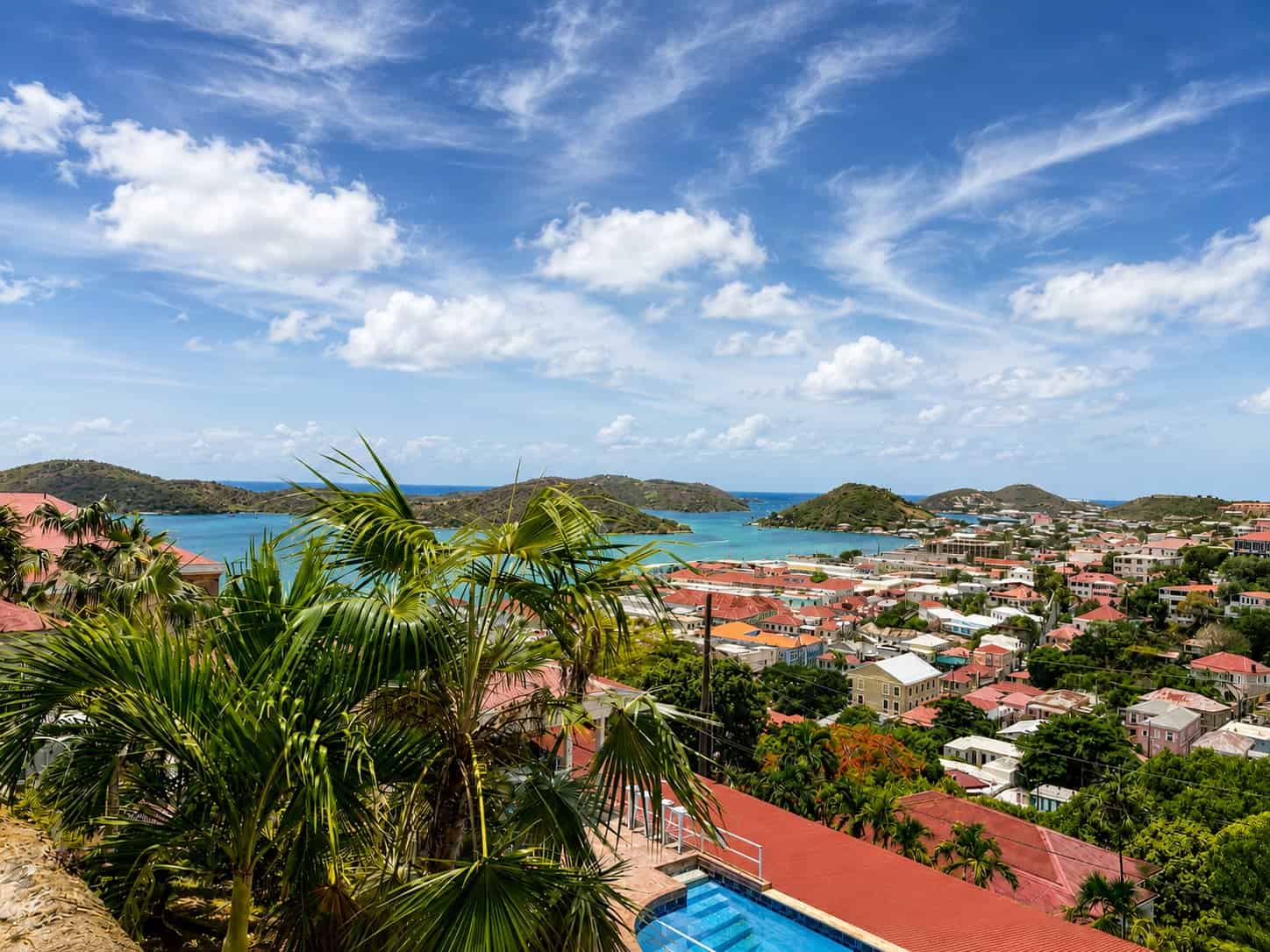 View over Charlotte Amalie harbor, red rooftops and the pool deck from a room at Blackbeard's Castle