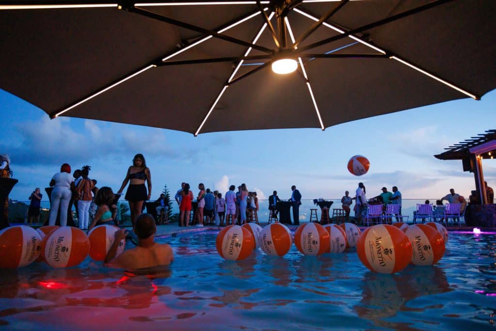 Guests filling the Jolly Roger's pool at dusk during a private party at Blackbeard's Castle