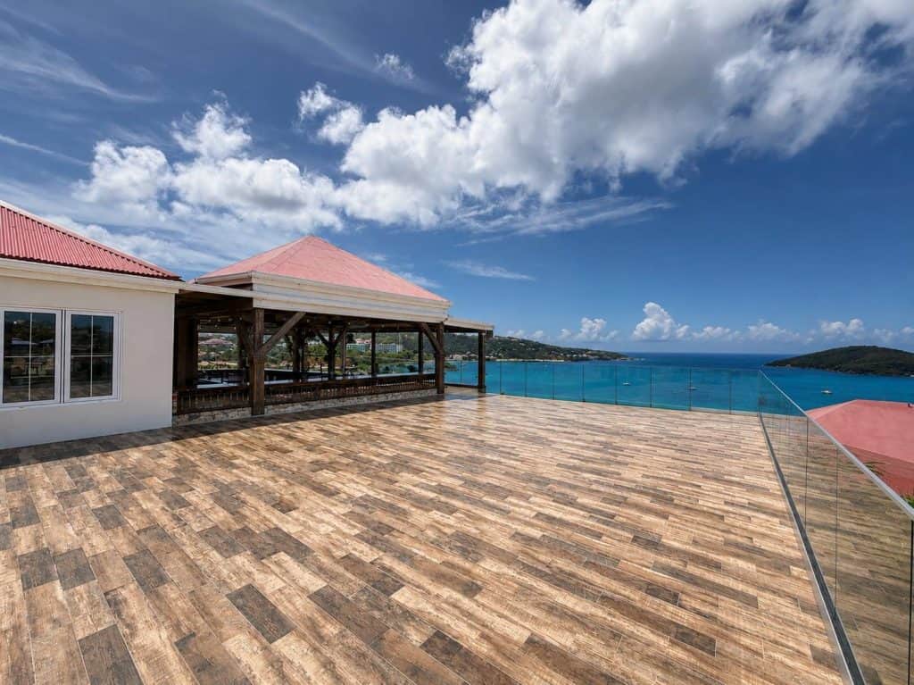 Harborview Terrace at Blackbeard's Castle, tiled event deck with the covered pavilion bar on one side and Charlotte Amalie harbour beyond the glass railing