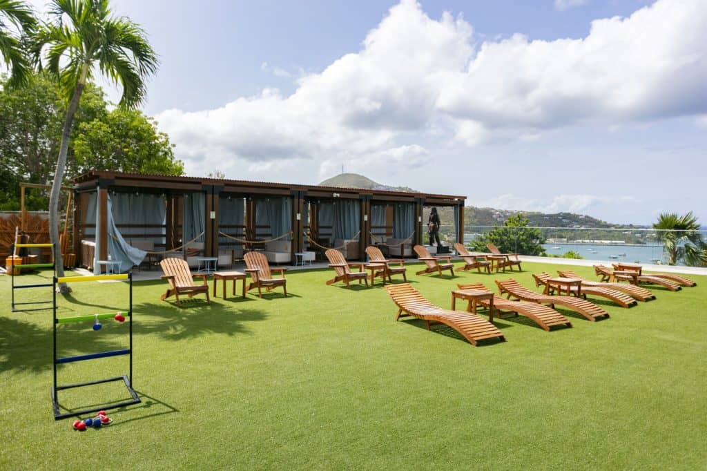 The lawn at Jolly Roger's with cabanas and lawn games set up for an event