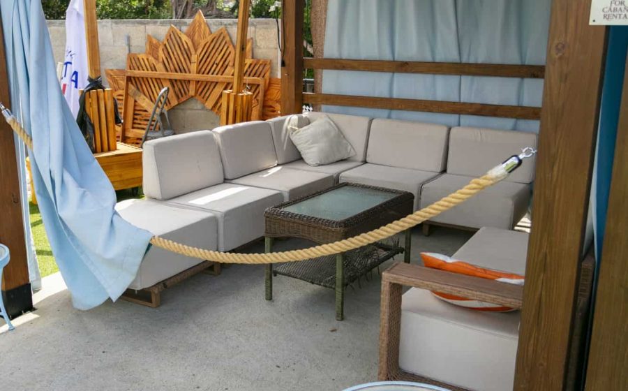 A shaded cabana lounge with seating at Jolly Roger's pool bar
